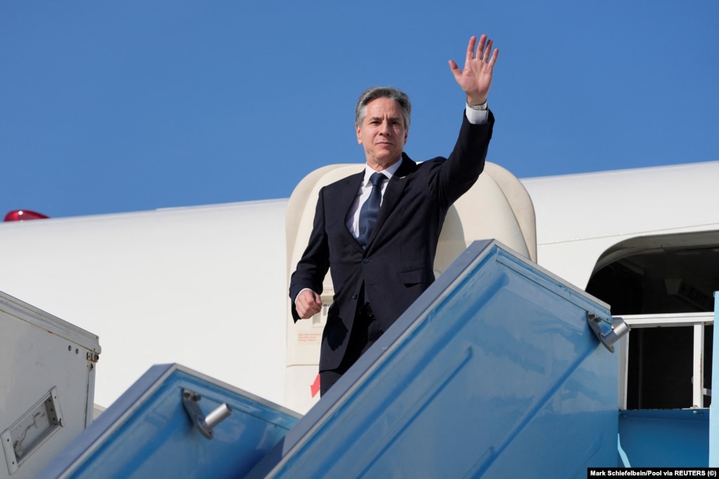 U.S. Secretary of State Antony Blinken waves as he boards his plane at an airport near Tel Aviv on February 8, during his trip to the Middle East