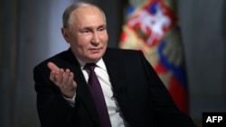 Russian President Vladimir Putin gives an interview to state media at the Kremlin in Moscow on March 12.