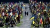 People walk through the cemetery of Lychakiv as they pay tribute to fallen soldiers during the Day of Remembrance of the Defenders of Ukraine, in Lviv on August 29.