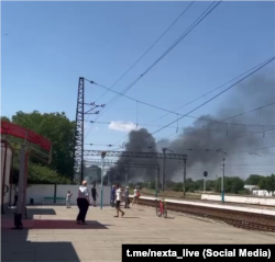 In this post from social media, the fire at an oil depot near the Elevatorna railway station can be seen in Oktyabrske, Crimea, on July 22.