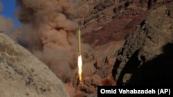  An Iranian Qadr H long-range ballistic surface-to-surface missile is fired during a training maneuver by Iran's Islamic Revolutionary Guards Corps. (file photo