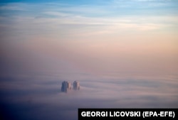 Buildings poke through a layer of fog and air pollution in Skopje on December 21.