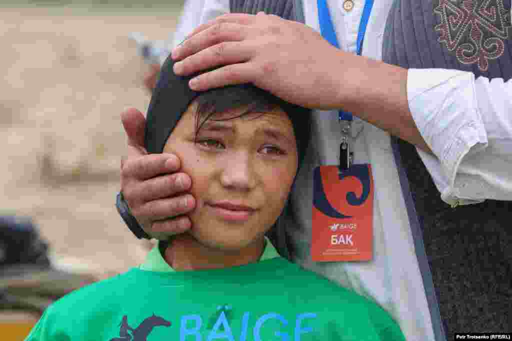 After competing and taking first place in a race for 2-year-old horses, 11-year-old Arnat Muratkhan, who is regarded as one of Kazakhstan&#39;s top equestrian competitors, is given a congratulatory pat on the head.
