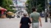 KOSOVO: Citizens walking in North Mitrovica, next to bridge crossing the Ibar river in Mitrovica, Kosovo, connecting South Mitrovica and North Mitrovica. 