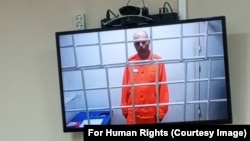 Vladimir Kara-Murza is shown on a video screen from his prison in Omsk at a hearing in June at which he requested permission to speak to his wife on their 20th wedding anniversary.