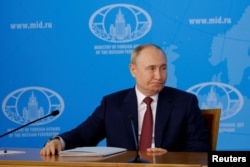 Russian President Vladimir Putin makes his statement on a cease-fire in Ukraine at a Moscow event on June 14.