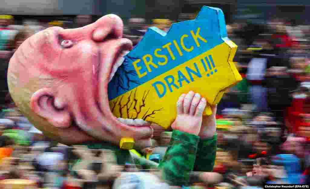 A carnival float depicting Russian President Vladimir Putin opening his mouth and trying to devour Ukraine is seen during the annual Rose Monday (Rosenmontag) Carnival parade in Duesseldorf, Germany.