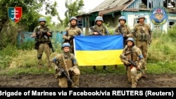 Ukrainian soldiers of the 35th Separate Brigade of Marines pose in Storozheve, Donetsk region, after liberating the village from the Russian Army on June 12. 