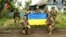 Ukrainian soldiers of the 35th Separate Brigade of Marines pose in Storozheve, Donetsk region, after liberating the village from the Russian Army on June 12. 