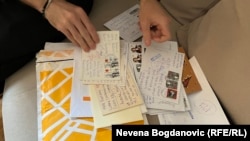 Hnyot showing letters of support he received during his seven-month detention in Belgrade's Main Prison.