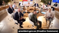 Ukrainian President Volodymyr Zelenskiy (foreground center) meets with G7 leaders at the group's summit in Italy in June. 