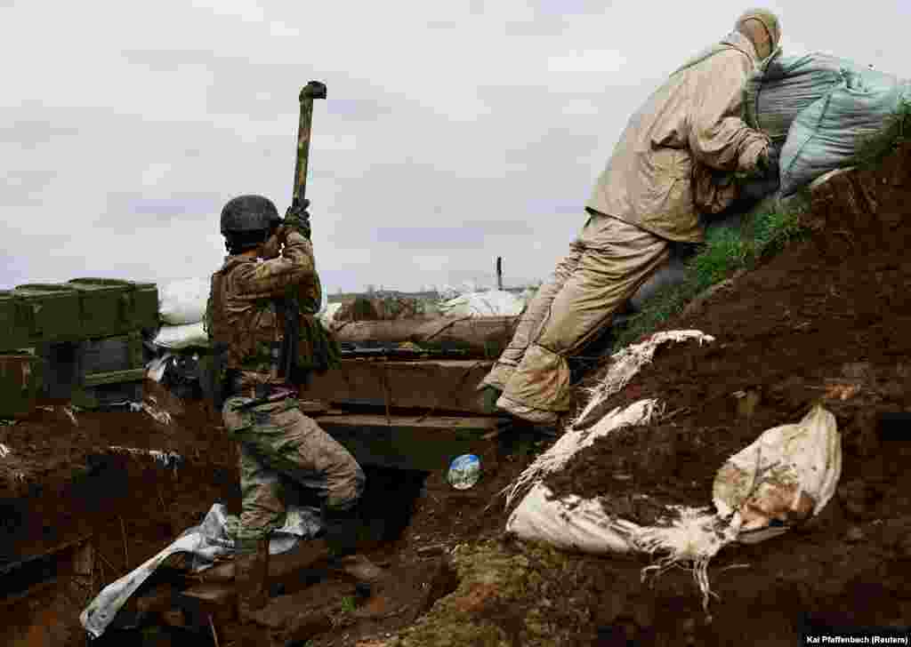 A Ukrainian soldier serving with the 24th Brigade observes Russian positions from a trench near New York, in eastern Ukraine, on April 4. While the world&#39;s attention has been focused on the battle for Bakhmut 30 kilometers to the north, these Ukrainian soldiers have also been fighting off Russian attacks. &nbsp;