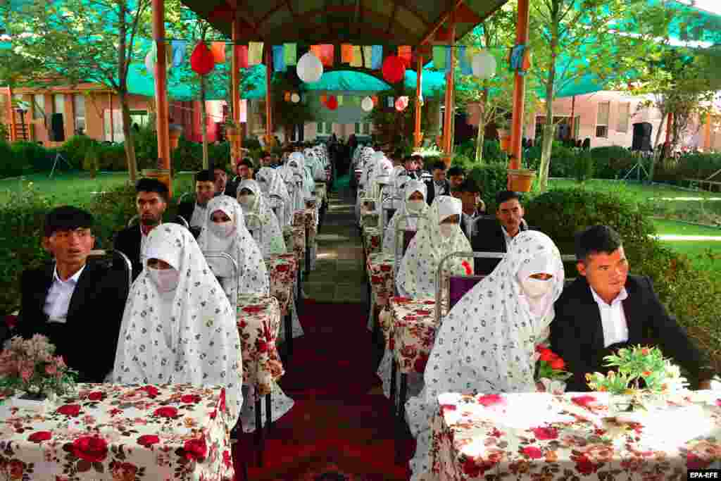 Brides and grooms participate in a mass marriage ceremony for 125 couples in Mazar-e Sharif, Afghanistan.