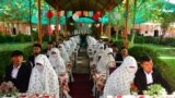 Brides and grooms participate in a mass marriage ceremony for 125 couples in Mazar-e-Sharif, Afghanistan.