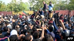 Supporters of Pakistan's former Prime Minister Imran Khan gather outside a court in Islamabad on March 18.