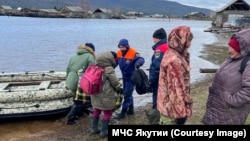Residents of a village in Russia's Yakutia region are evacuated on May 13. 