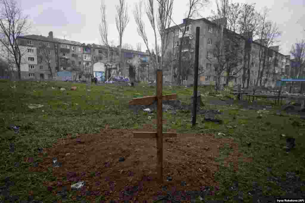 A cross marks the grave of a resident killed by Russian shelling in Bakhmut.
