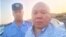 Amangeldy Batyrbekov (right) takes a selfie after his trial on July 3.