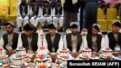 Afghan grooms attend a mass wedding ceremony at a hall in Kandahar, Afghanistan, on February 28.