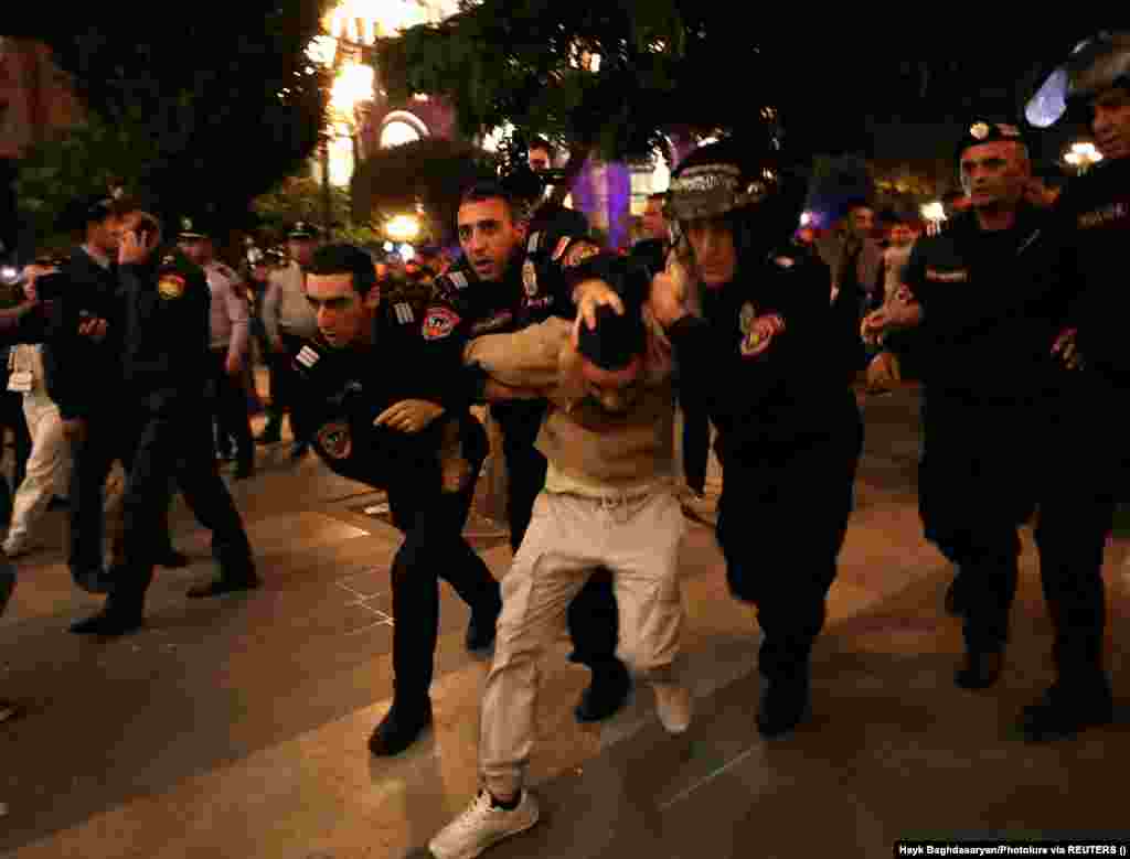 Law enforcement officers detain a protester near a government building in Yerevan on September 21. Baku says it has plans to reintegrate Nagorno-Karabakh and its ethnic Armenian population back into Azerbaijan. But the Azerbaijani authorities aren&#39;t saying what the plan is, and the details remain far from clear. The first session of &quot;reintegration&quot; talks ended on September 21 without any sign of a breakthrough.