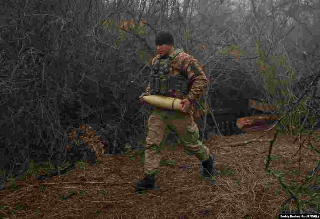 A Ukrainian soldier carries shells to an awaiting howitzer. Ukrainian President&nbsp;Volodymyr Zelenskiy claimed in an interview on March 11 that Russian advances had been &quot;halted.&quot; Battlefield claims cannot be independently verified.