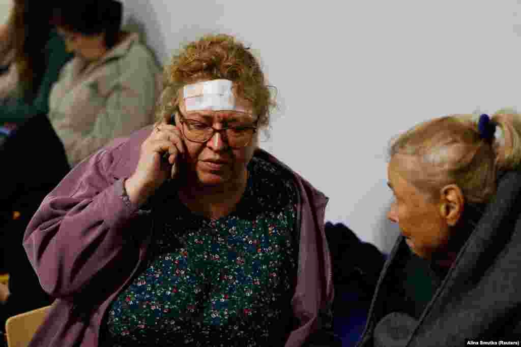 An injured woman at the site of the missile attack. At least seven individuals were reportedly trapped under the rubble, prompting search-and-rescue efforts.