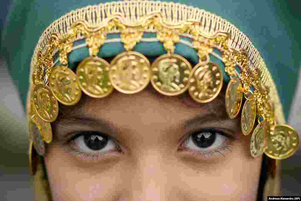 A girl poses for a portrait after Eid al-Fitr prayers in Bucharest on April 21. Members of the Muslim community worldwide gathered for Eid al-Fitr prayers, marking the end of the holy fasting month of Ramadan.