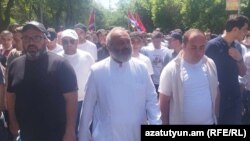 A procession led by Archbishop Bagrat Galstanian (center) moves toward Yerevan State University on May 10.