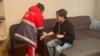 A medic treats Kazakh journalist Daniyar Moldabekov after he was attacked in his apartment building in Almaty on February 22. 