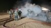 Firefighters work to put out the blaze following an explosion at a highway construction site in Romania early on September 21.