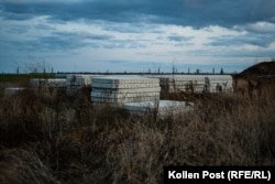 Stacks of concrete slabs have been waiting in a field since the beginning of 2022.