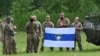Fighters from the Free Russia Legion pose in northern Ukraine, not far from the Russian border, on May 24. Some of the hacks claimed to be on their behalf. 