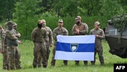 Fighters from the Free Russia Legion pose in northern Ukraine, not far from the Russian border, on May 24. Some of the hacks claimed to be on their behalf. 