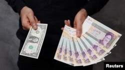 شهروندی با در دست داشتن یک دلار آمریکا، معادل ریالی آن را نشان می‌دهد؛ زمانی که دلار ۴۵ هزار تومان بود