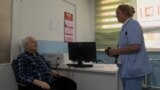 Bosnia and Herzegovina, Gerontological Center Sarajevo. A user with a nurse in the clinic.