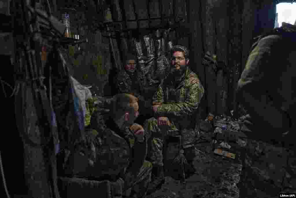 Ukrainian soldiers have a short rest in a shelter on the front line in Bakhmut.