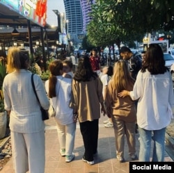 Women defying the mandatory hijab in Iran.