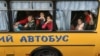 Children gesture as they are evacuated from the Russian-occupied town of Kupyansk town on the outskirts of Kharkiv, on May 30, 2022.