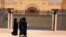 Women walk past the Iranian embassy in Riyadh, which will reopen on June 6. (file photo)