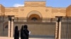 Women walk past the currently shuttered Iranian Embassy in the diplomatic quarter of the Saudi capital, Riyadh, on April 11. 