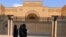 Women walk past the currently shuttered Iranian Embassy in the diplomatic quarter of the Saudi capital, Riyadh, on April 11. 