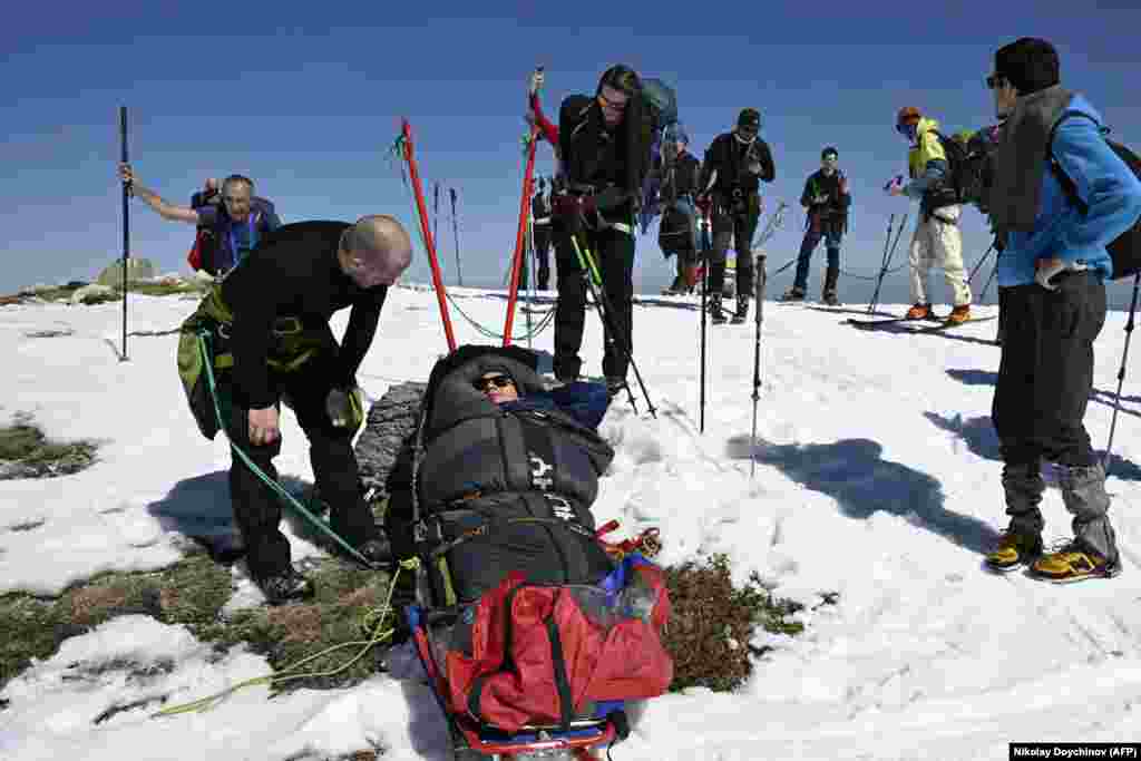 Volunteers take a break from pulling Lybomir Elenkov, who has cerebral palsy, up the Rila Mountains.&nbsp; Doychinova and her team are now working on organizing summer outings that will include a hike up Vitosha, the iconic mountain that rises above Bulgaria&#39;s capital, Sofia.&nbsp;