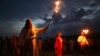 People with torches wearing traditional Russian village-style clothes celebrate the summer solstice near a bonfire in the village of Okunevo, about 200 kilometers northeast of the Siberian city of Omsk.