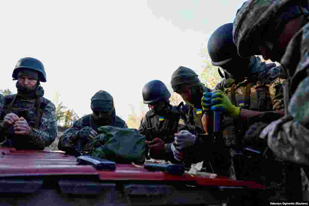 Members of the unit load ammunition into magazines.