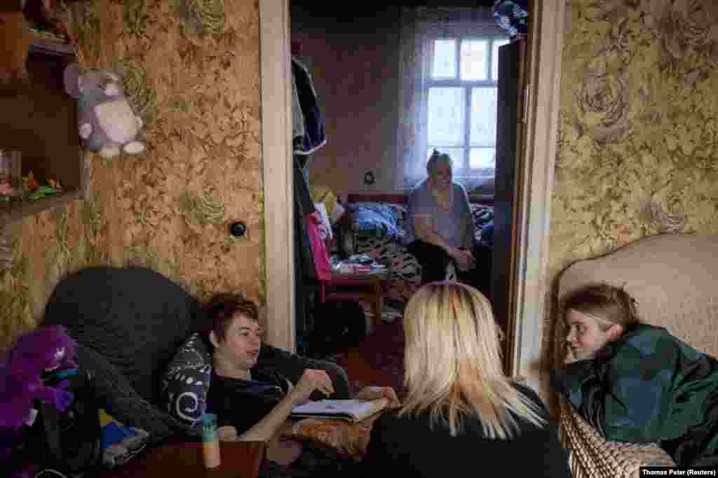 For most of 2022, when the Russians were less than a kilometer away from the village, the shelling was especially frightening for Ivan. &quot;He couldn&#39;t sleep at night,&quot; recalls Ivan&#39;s grandmother, 76-year-old Olena Martynenko, the boy&#39;s primary caregiver (pictured) as he interacts with volunteers Korzun and Bezkluba. &nbsp; &nbsp;