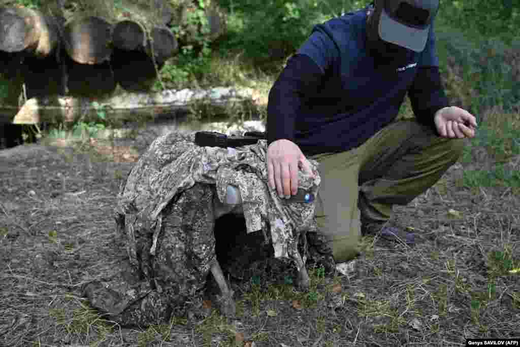 An operator with call sign Yuri demonstrates the capabilities of a robot dog at an undisclosed location in Ukraine. Stealthy and agile, robot dogs could soon become a common sight on the front in Ukraine, replacing soldiers for perilous missions like spying on Russian trenches or detecting mines.&nbsp;