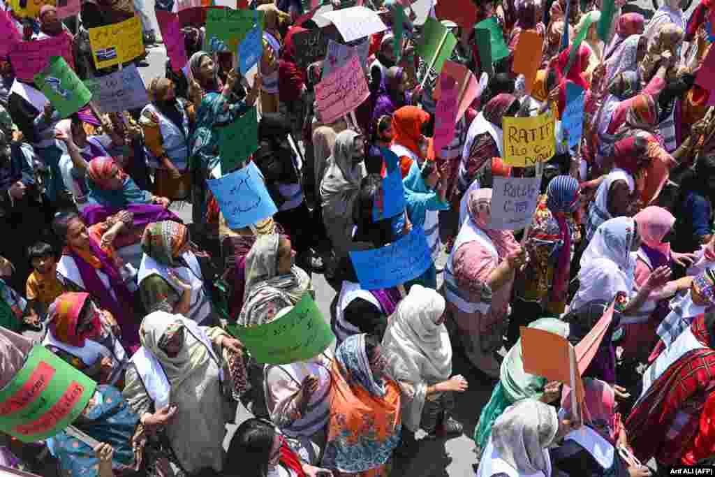 Female Pakistani workers march along a street to mark International Labor Day in Lahore.