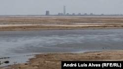The view of the Russian-occupied Zaporizhzhya nuclear power plant from the Nikopol embankment across the Dnieper River reservoir, which is almost completely dried up following a dam breach downstream.
