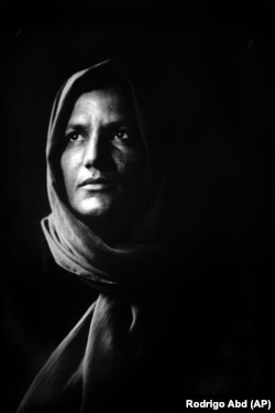 Zermine, 32, has three children. Her husband was killed in a suicide attack by the Taliban five years ago. She now toils in a carpet factory in Kabul.