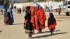 Afghan migrants arrive from Pakistan at the Afghanistan-Pakistan border in the Spin Boldak district of Afghanistan's Kandahar Province early last month. 